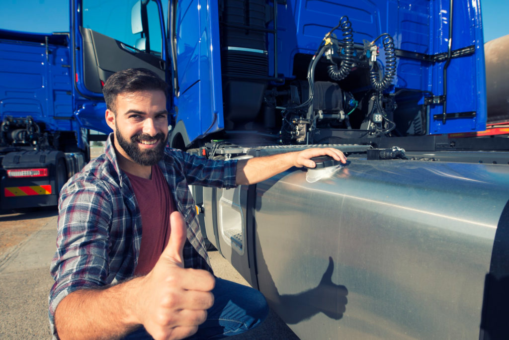 truck-driver-opening-reservoir-tank-refuel-truck-holding-thumbs-up